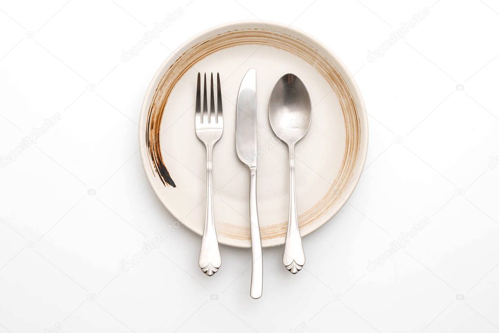empty plate spoon fork and knife isolated on white background