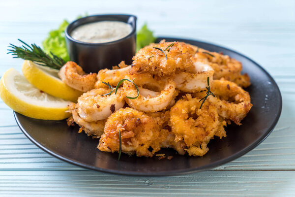 fried squids or octopus (calamari) with sauce - unhealthy foods