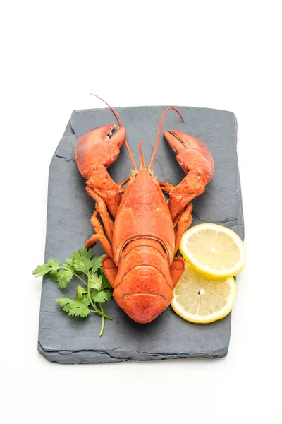 freshly boiled lobster on slate plate isolated on white background