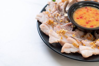 Soslu ve sebzeli haşlanmış balık sosu.