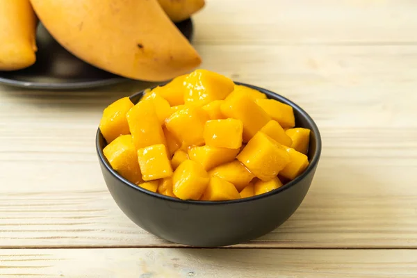 fresh and golden mangoes in bowl