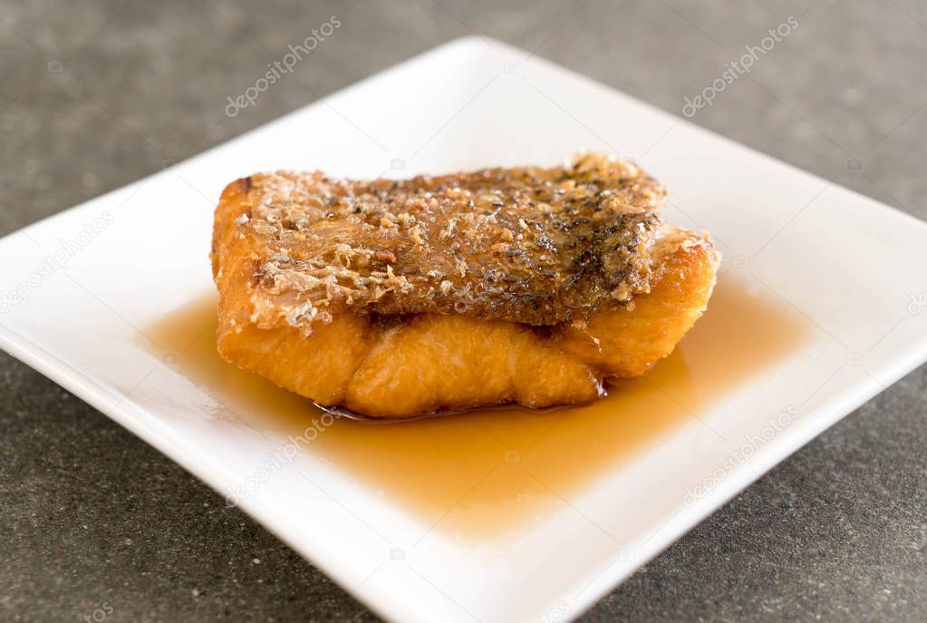 Fried Snapper Fish with Fish Sauce on white plate