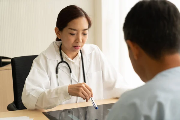 Asian Female Doctor Patient Discussing Something While Sitting Table Selective Royalty Free Stock Images