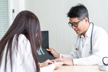 Asyalı doktor ve hasta röntgen film Office ile görüşüyorlar