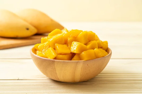 fresh and golden mangoes in bowl