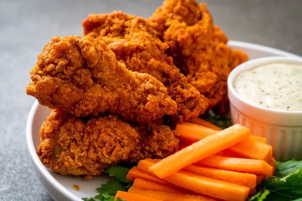 fried spicy chicken wings with vegetable