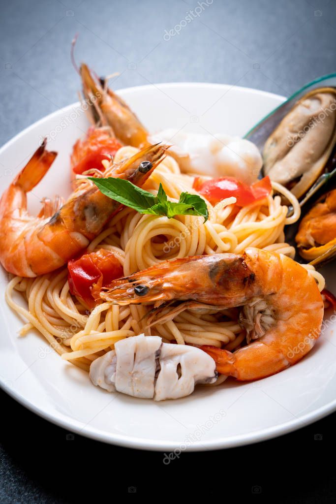 Seafood pasta Spaghetti with Clams, Prawns, Squis, Mussel and Tomatoes - Italian food style