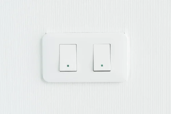 White light switch on wall