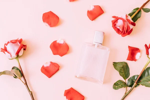 perfume bottle with rose petal on background