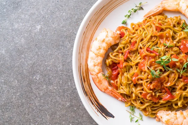 vegetable noodle with tomatoes sauce and shrimps on plate