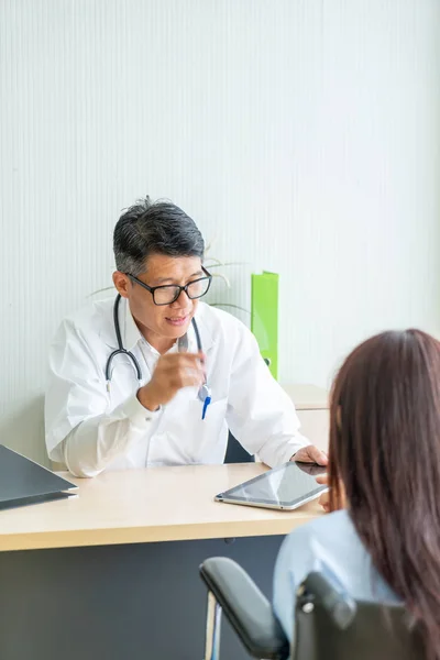 Asian Doctor Patient Consultation Discussing Something While Sitting Table Stock Image