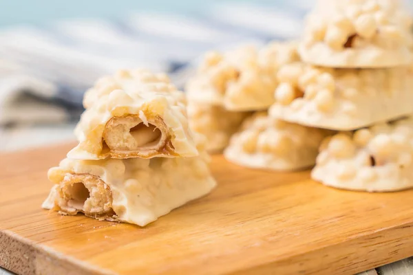 white chocolate with caramel and cereal crispy bar on wood