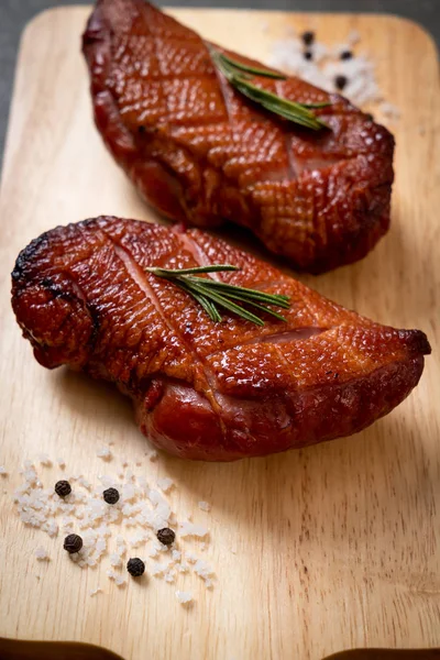 grilled duck breast on wood board