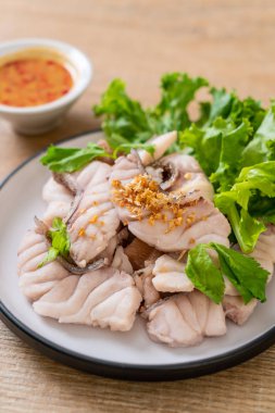 Soslu ve sebzeli haşlanmış balık sosu.