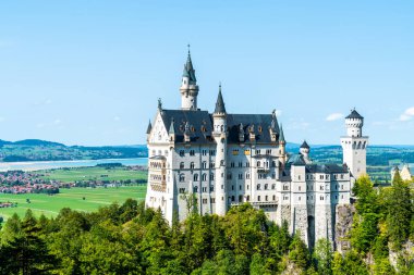 Beautiful Architecture at Neuschwanstein Castle in the Bavarian Alps of Germany with blue sky clipart