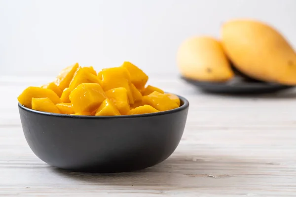 fresh and golden mangoes in bowl