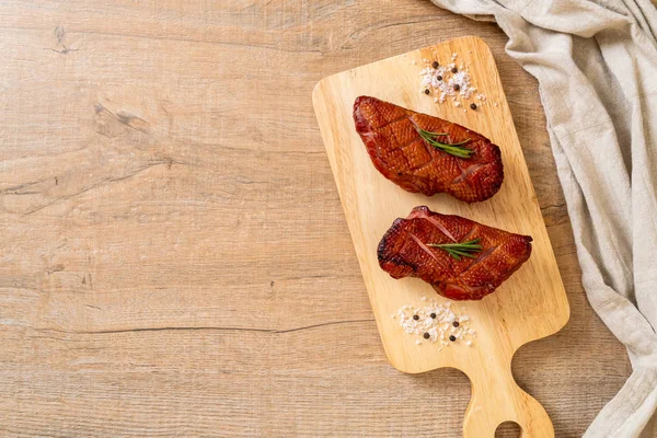 grilled duck breast on wood board