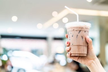 yakın çekim el buzlu Belçika çikolatalı milkshake Kupası tutarak