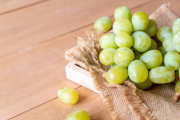 ahşap arka plan üzerinde taze yeşil üzüm