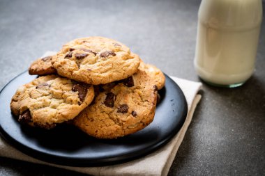 Tabağında çikolata parçaları olan kurabiyeler.