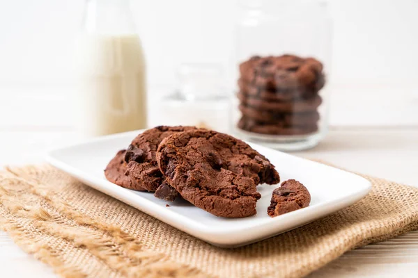 chocolate cookies with chocolate chips on wood background