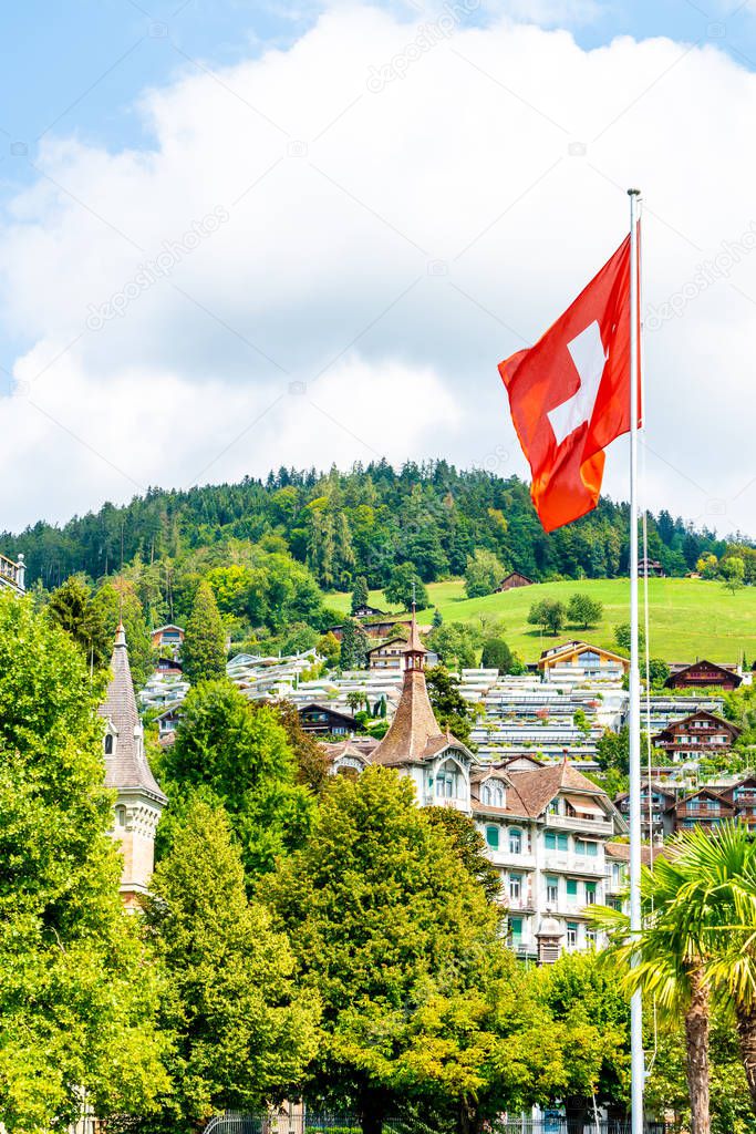 swiss flag with blue sky and city