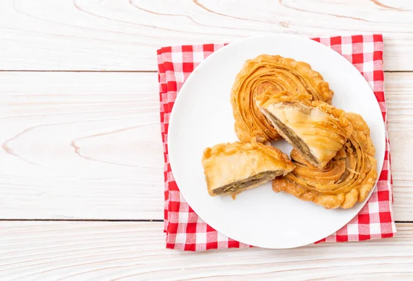 chicken curry puff pastry on wood background
