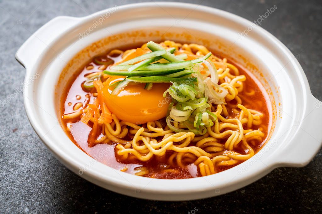 korean spicy instant noodles with egg, vegetable and kimchi - korean food style