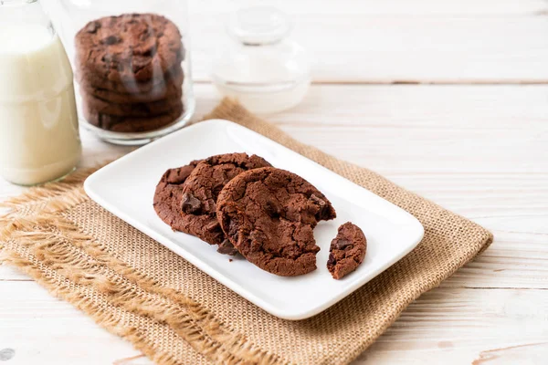chocolate cookies with chocolate chips on wood background