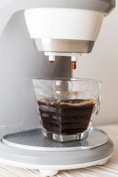 coffee maker machine making coffee on wood background