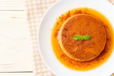 Ev yapımı karamel kremalı puding ahşap arka plan üzerinde