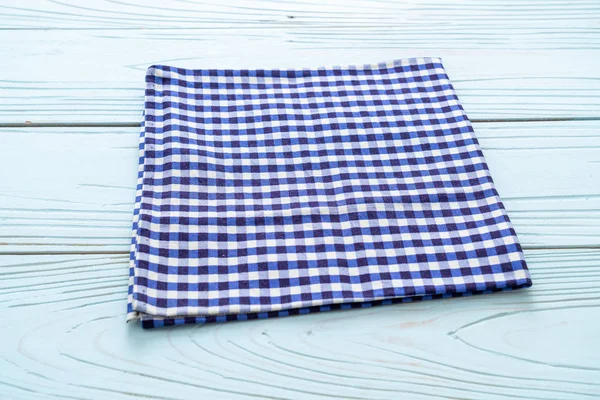 kitchen cloth (napkin) on blue wooden background with copy space