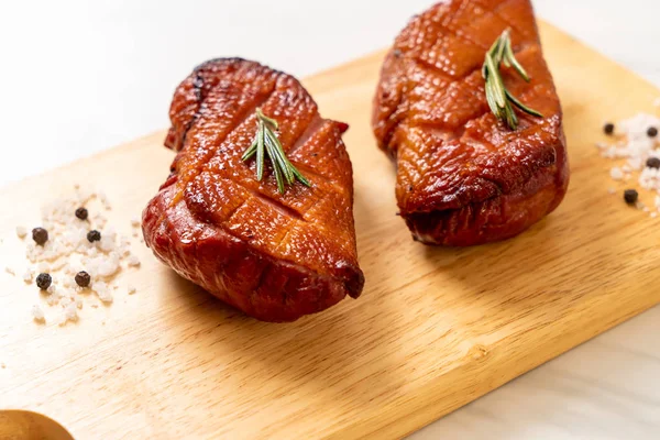 grilled duck breast on wood board