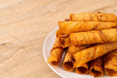 Çıtır çıtır kurutulmuş kalamar ruloları tabakta.