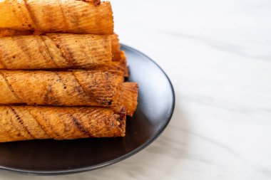 Çıtır çıtır kurutulmuş kalamar ruloları tabakta.