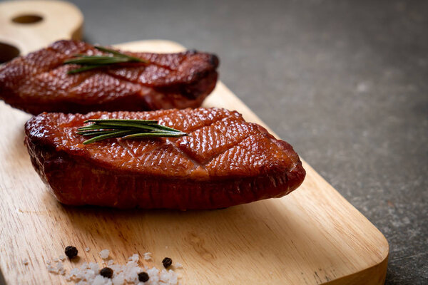 Grilled duck breast on wood board