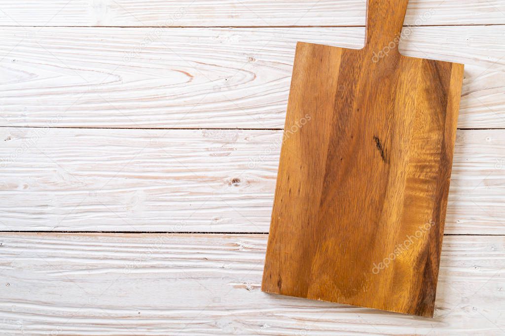 empty cutting wooden board with kitchen cloth on wood background