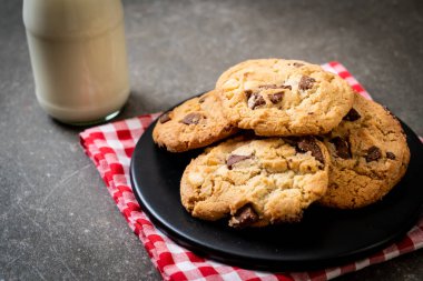 Tabağında çikolata parçaları olan kurabiyeler.