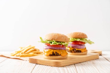 taze lezzetli biftek burger peynir ve patates kızartması ahşap arka plan üzerinde