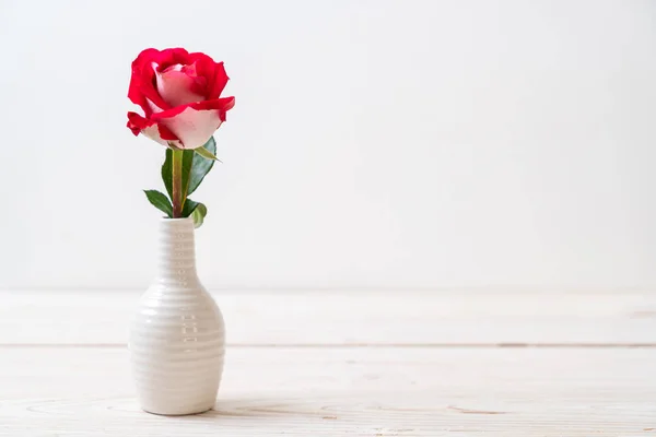 red rose on wood background