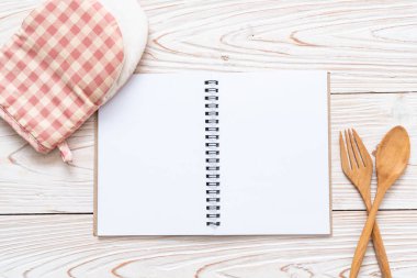 metin Not ahşap yüzey ve tahta kaşık ve çatal ile kopya sapce için boş defter