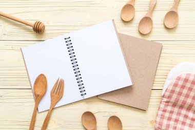 metin Not ahşap yüzey ve tahta kaşık ve çatal ile kopya sapce için boş defter