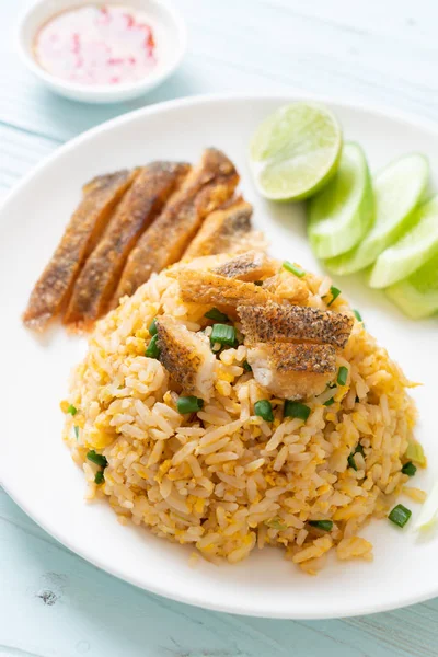 fried rice with crispy gourami fish - Asian food style