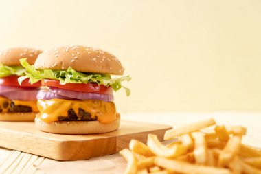 taze lezzetli biftek burger peynir ve patates kızartması ahşap arka plan üzerinde