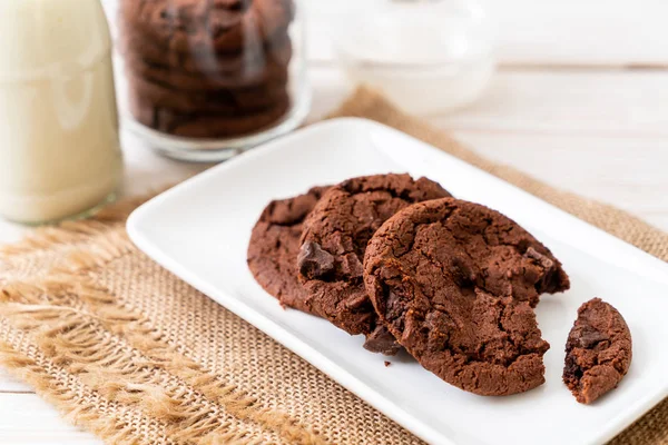 chocolate cookies with chocolate chips on wood background