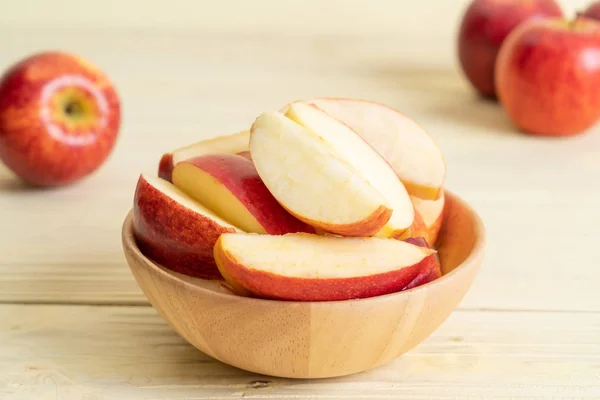 stock image fresh red apples sliced bowl on wood background