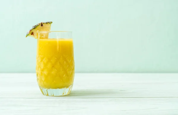 Fresh pineapple smoothie glass on wood table — Stock Photo, Image
