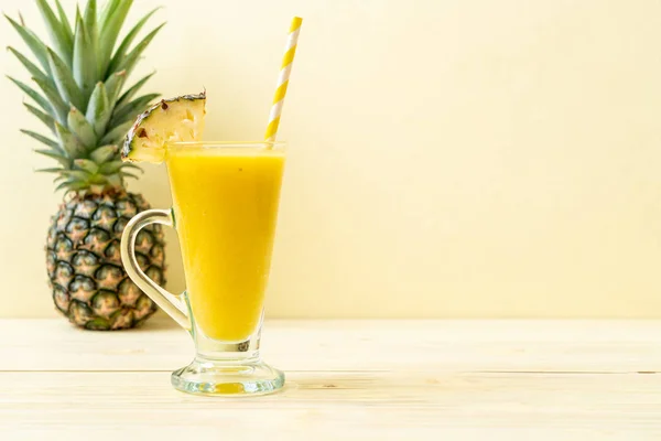 Fresh pineapple smoothie glass on wood table — Stock Photo, Image