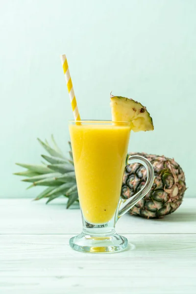 Fresh pineapple smoothie glass on wood table — Stock Photo, Image