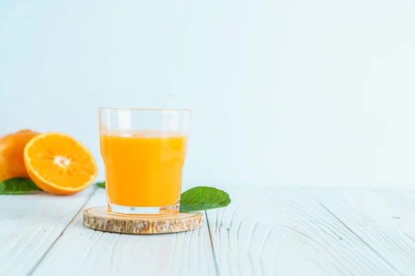 Jus d'orange frais sur fond de bois — Photo